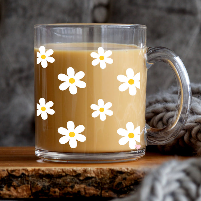 a cup of coffee with white flowers on it