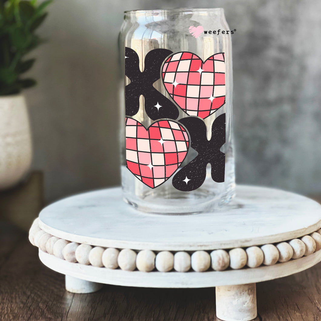a glass jar with a design of two hearts on it