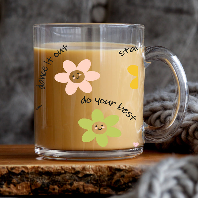 a glass mug with a smiley face on it