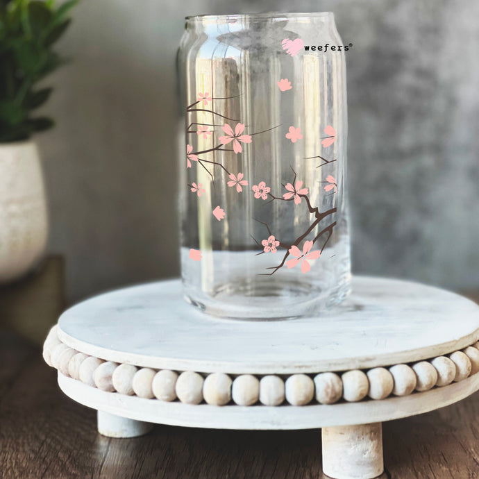 a glass vase with pink flowers painted on it