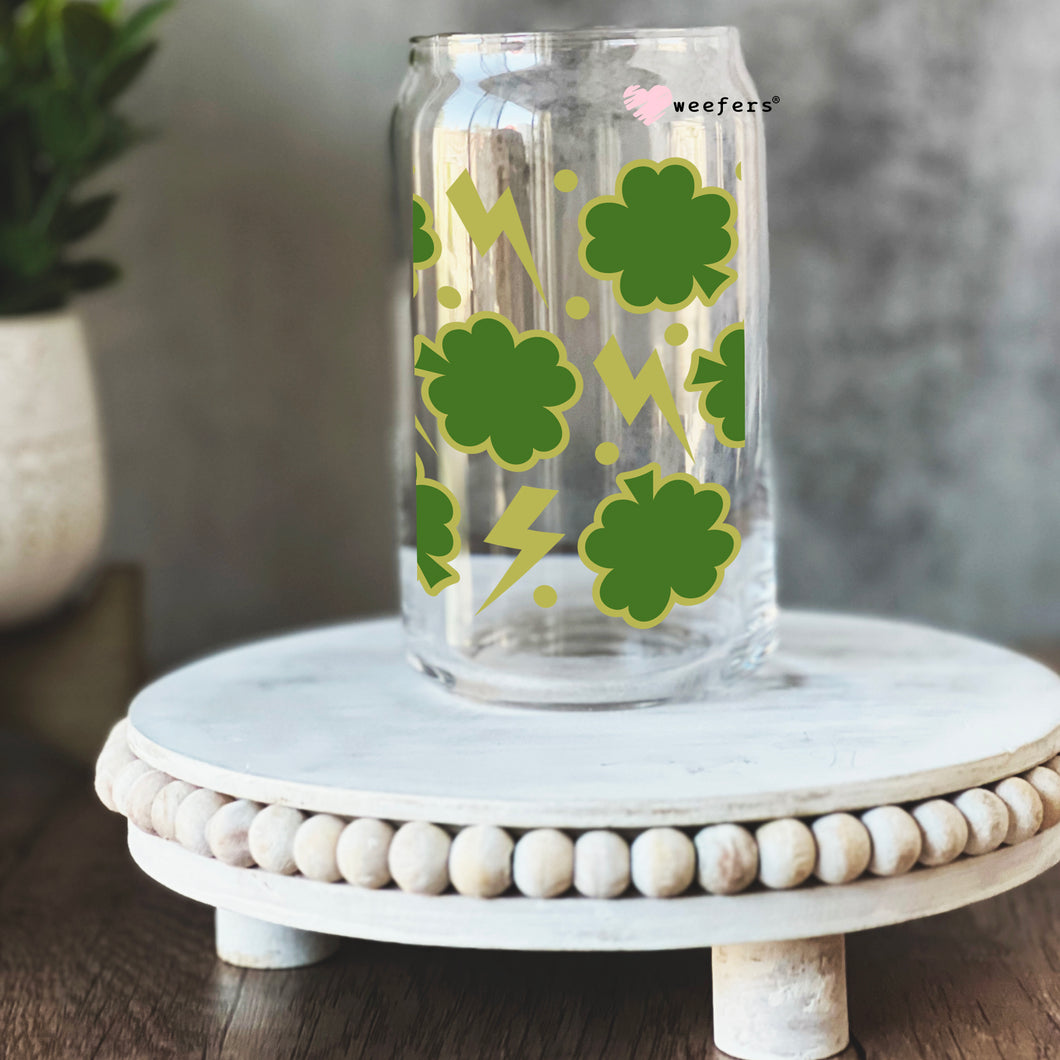 a glass jar with shamrocks painted on it