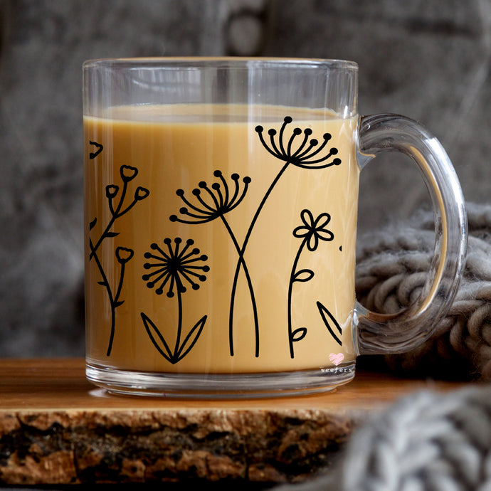 a glass mug with a brown liquid inside of it