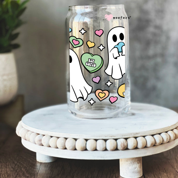 a glass jar with a ghost and heart stickers on it