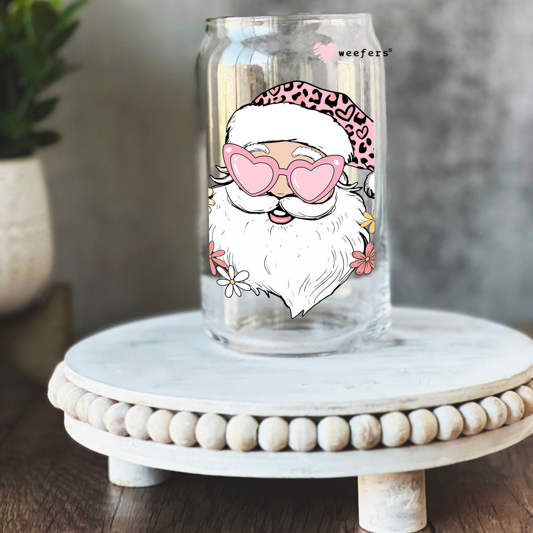 a glass jar with a picture of santa claus on it