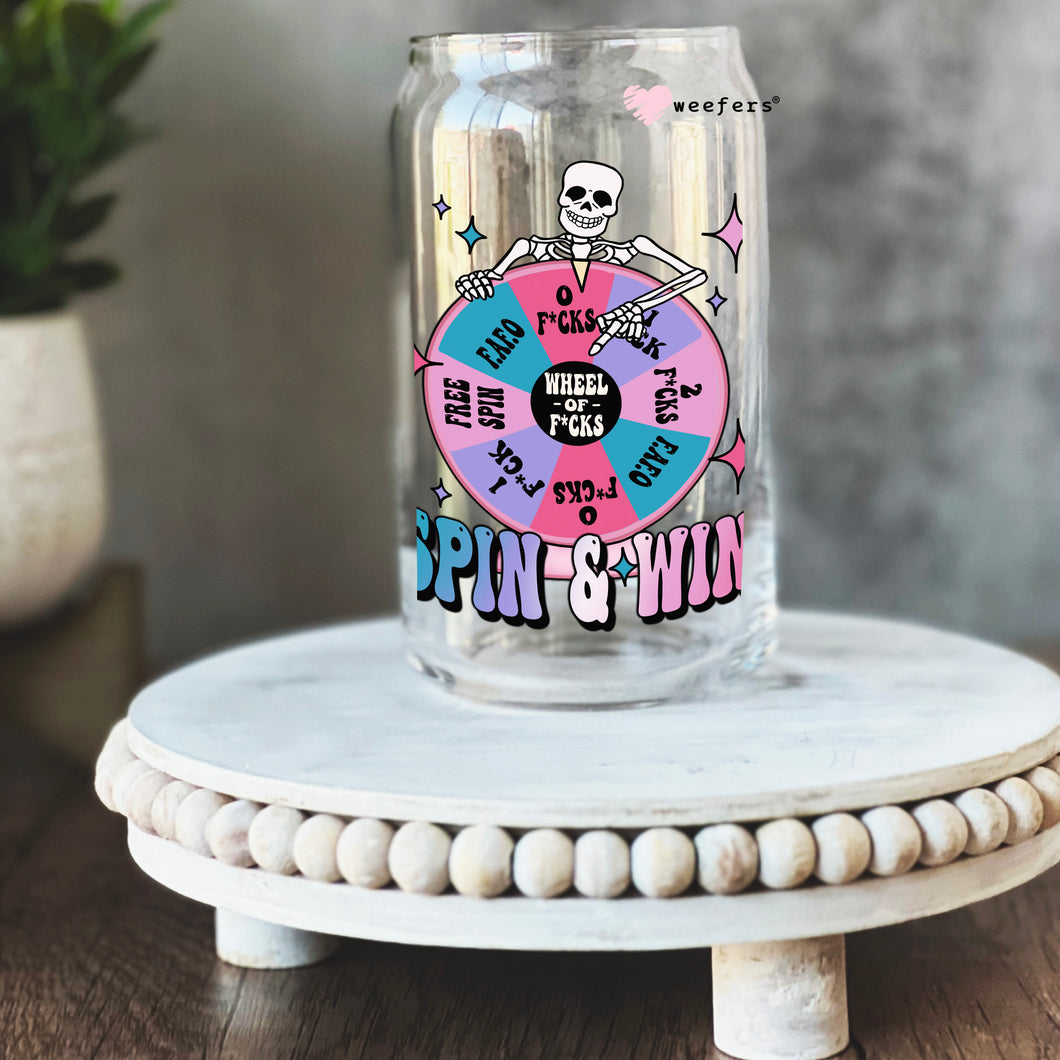 a glass jar with a skeleton on it sitting on a table