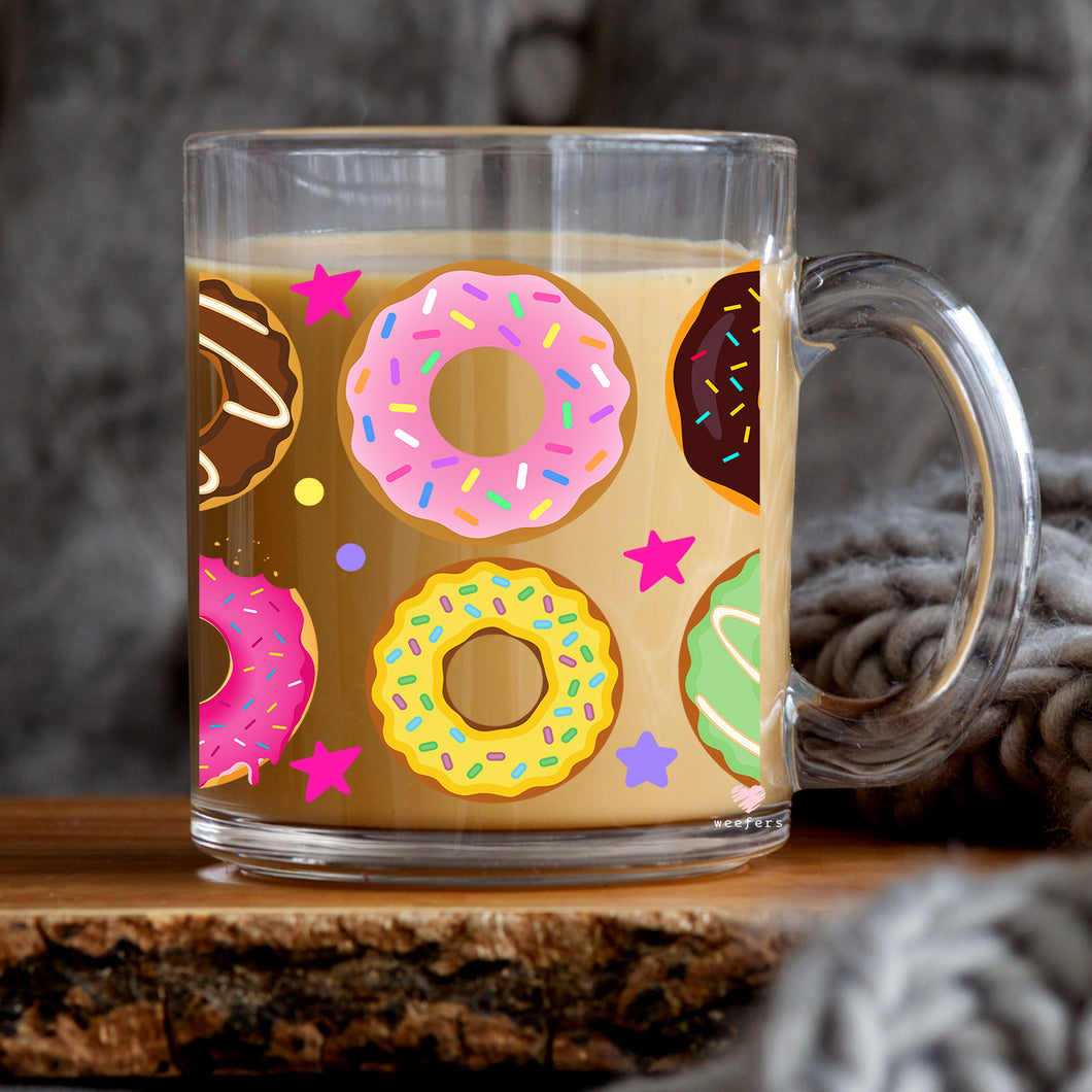 a cup of coffee with donuts painted on it