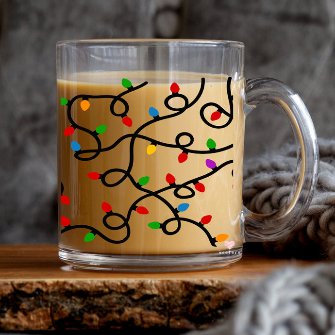 a glass mug with a christmas tree drawn on it