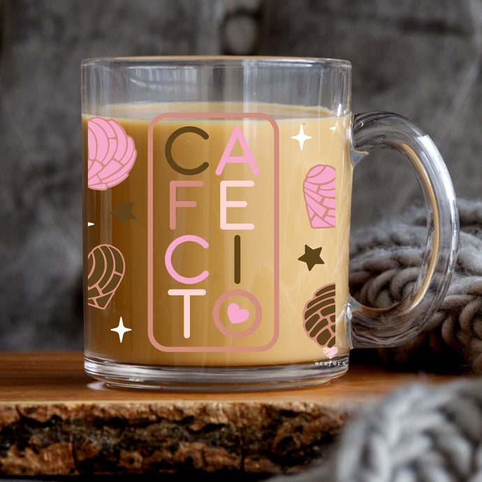 a glass mug with a pink and brown design on it