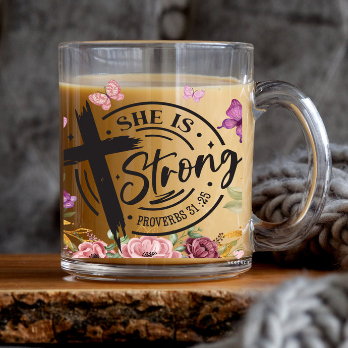 a glass mug with the words she is strong on it