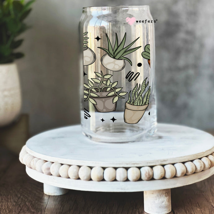 a glass jar with a plant design on it