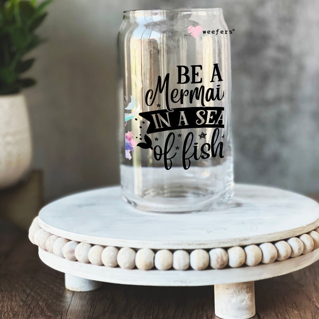a glass jar that says be a mermaid in a sea of fish