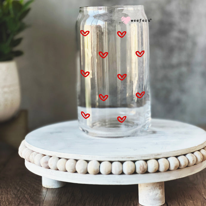a glass jar with hearts drawn on it