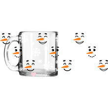 Load image into Gallery viewer, a glass mug with a snowman face drawn on it
