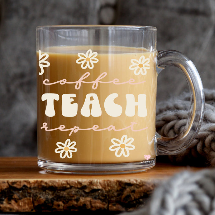 a coffee mug with the words teach on it